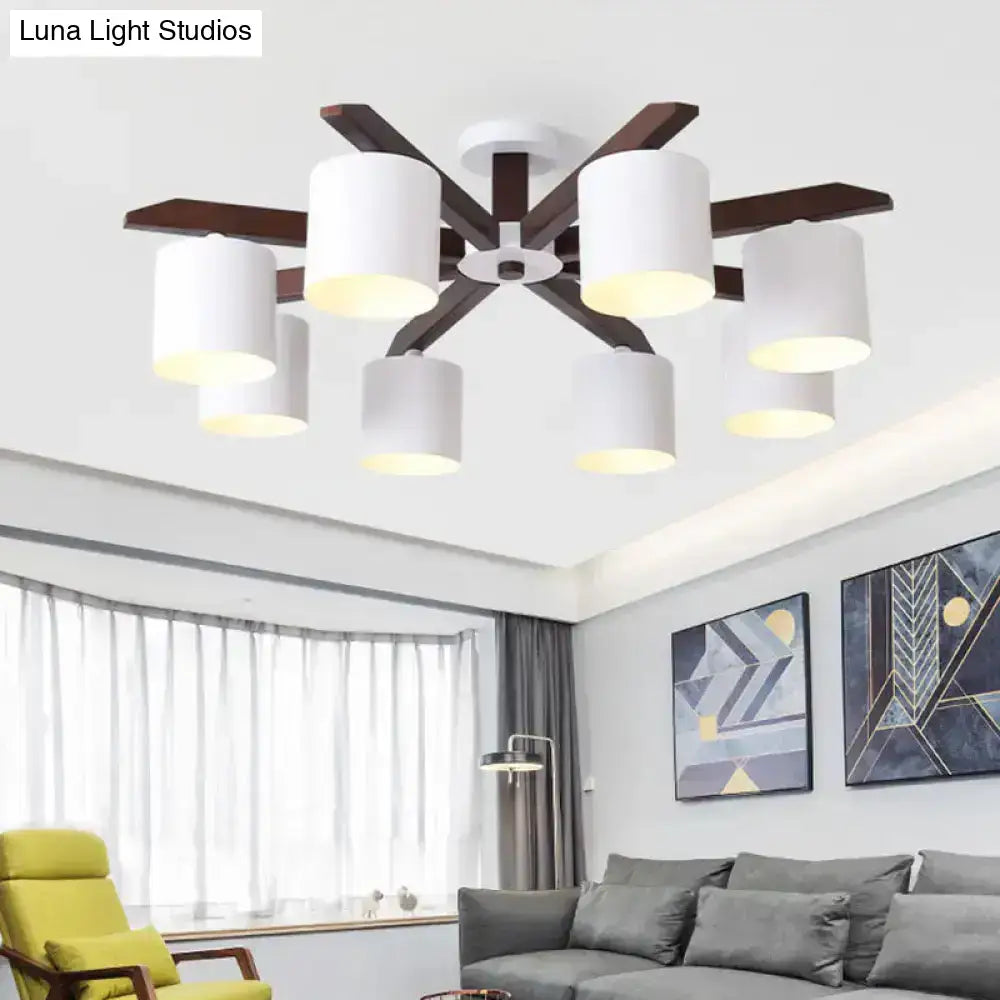 Modern brown and white ceiling mount chandelier with six white cylindrical shades on dark wood frame for living room