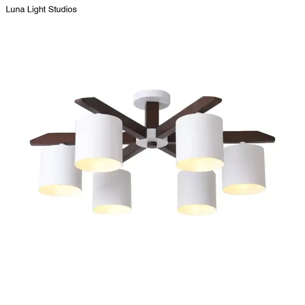 Modern brown and white ceiling mount chandelier with six white cylindrical shades and dark wood arms for living room