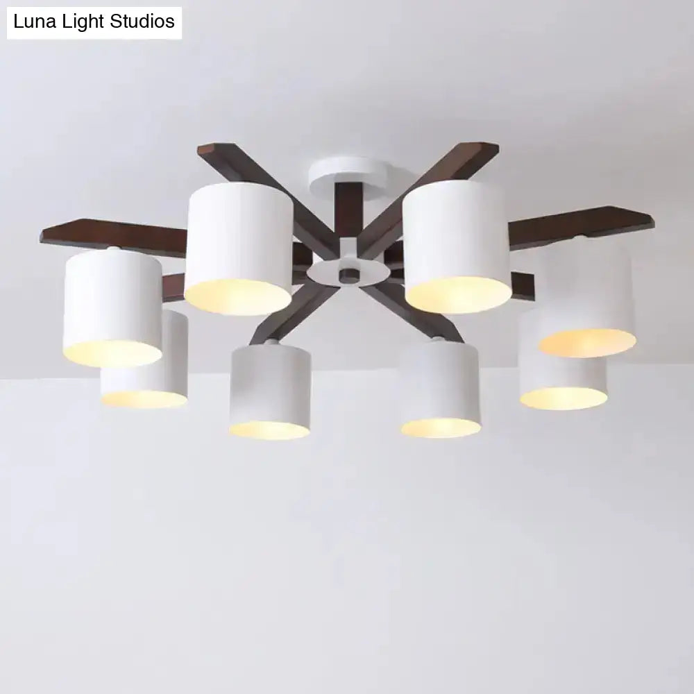 Modern brown and white ceiling mount chandelier with six white cylindrical shades and dark wood arms for living room