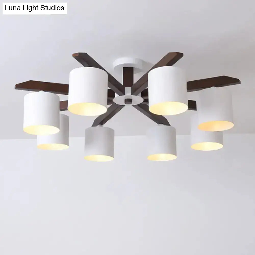 Modern brown and white ceiling mount chandelier with six cylindrical shades and dark wood arms for living room lighting