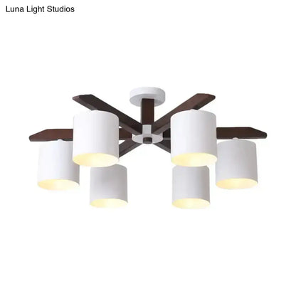 Modern brown and white ceiling mount chandelier with six white cylindrical shades and dark wood arms for living room