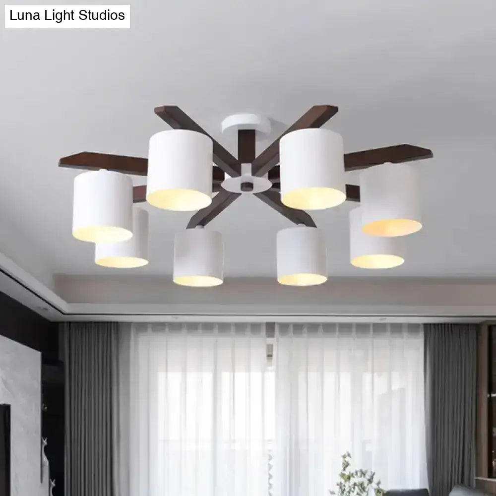 Modern brown and white ceiling mount chandelier with six cylindrical shades and dark wood arms for living room lighting