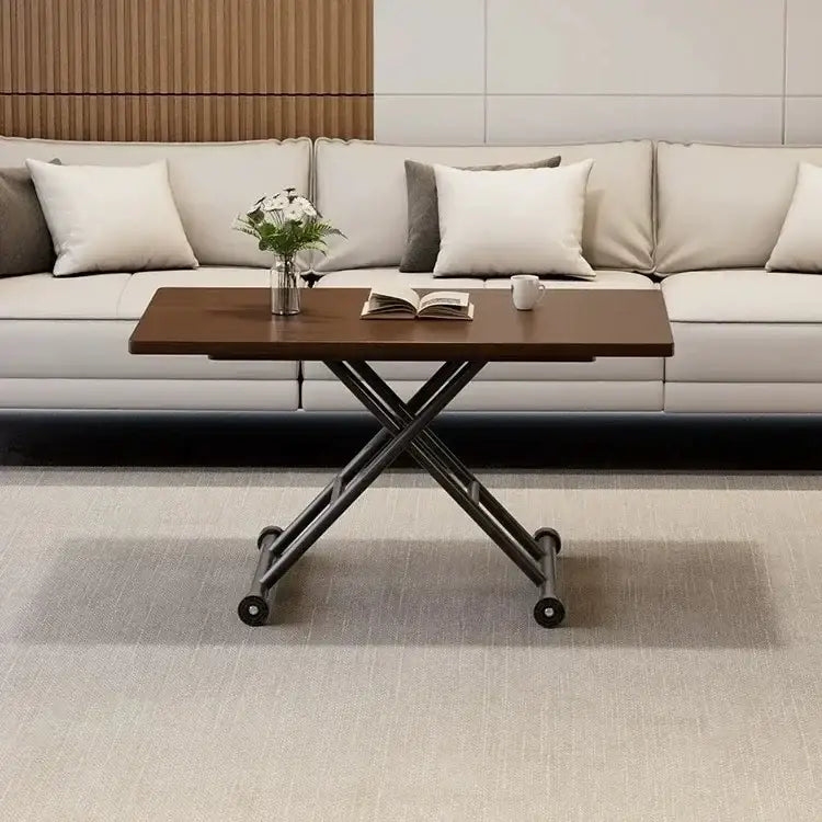 A modern brown wood adjustable coffee table with a matte finish top, black metal x-frame legs, and caster wheels