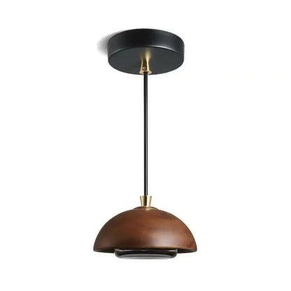 A modern brown finish pendant light with a dome-shaped wooden shade and black metal hardware for kitchen island