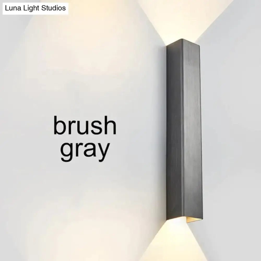 Modern brushed aluminum rectangular wall sconce in gray with a sleek matte finish for bedroom ambient lighting
