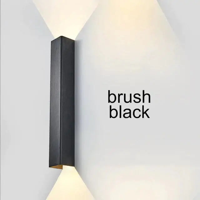 Modern brushed aluminum rectangular wall sconce in black with angled light beams for ambient bedroom lighting