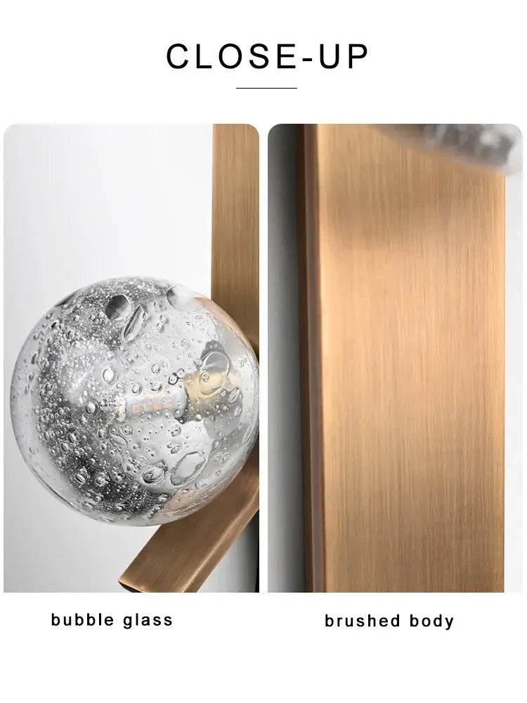 Modern brushed brass wall sconce lamps with a spherical bubble glass knob and frosted glass for bedroom use