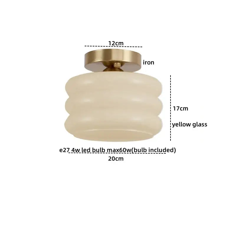 Modern brushed brass ceiling light featuring cream-colored layered yellow decorbites creamy glass with iron fixture