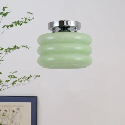 A mint green ribbed glass ceiling light with chrome ceiling mount as part of decorbites creamy glass iron collection