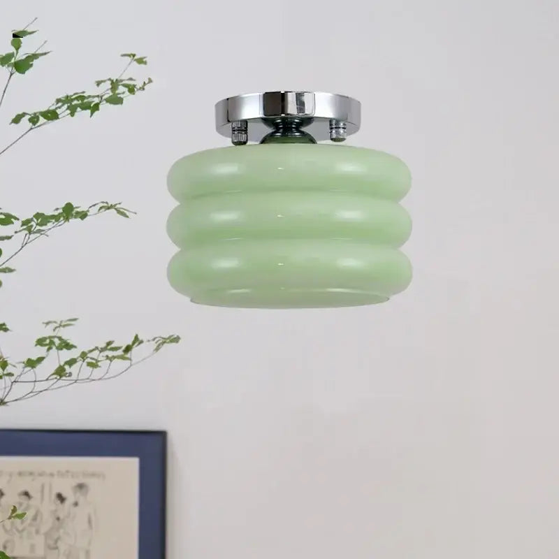 A mint green ribbed glass ceiling light with chrome ceiling mount as part of decorbites creamy glass iron collection