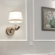 Modern brushed brass sconce light with clear crystal accent and white fabric shade for hallway wall light use
