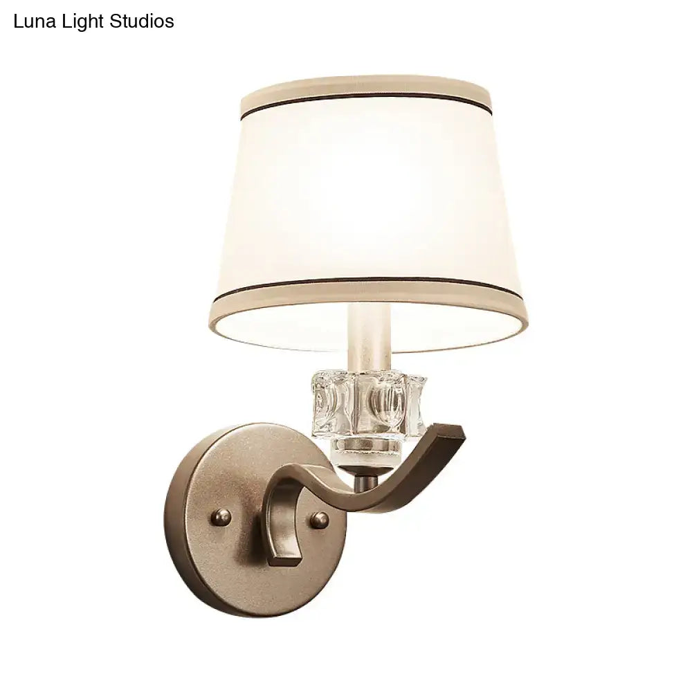 Modern brushed brass sconce light with crystal accent and off-white lampshade for elegant hallway wall light