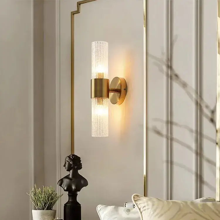 Modern brushed brass crystal wall lamp featuring a gold-toned wall sconce with textured frosted glass diffuser for warm bedroom lighting