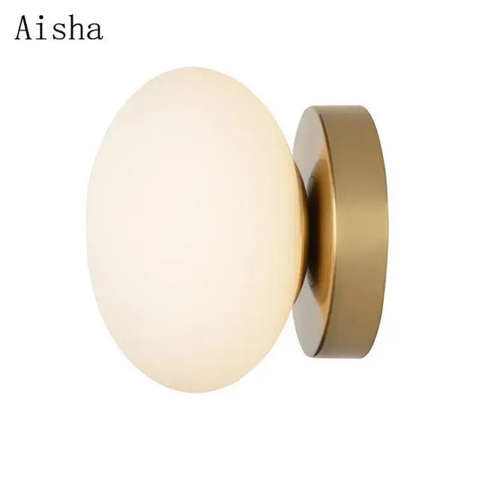 Aisha brand wall lamp with a frosted golden glass ball and brushed brass base for modern decorbites golden glass decor