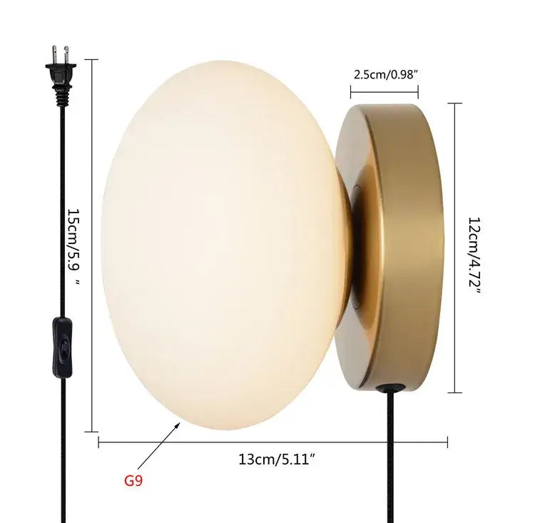 A modern wall lamp with a frosted opal golden glass ball and brushed brass base from decorbites golden glass collection