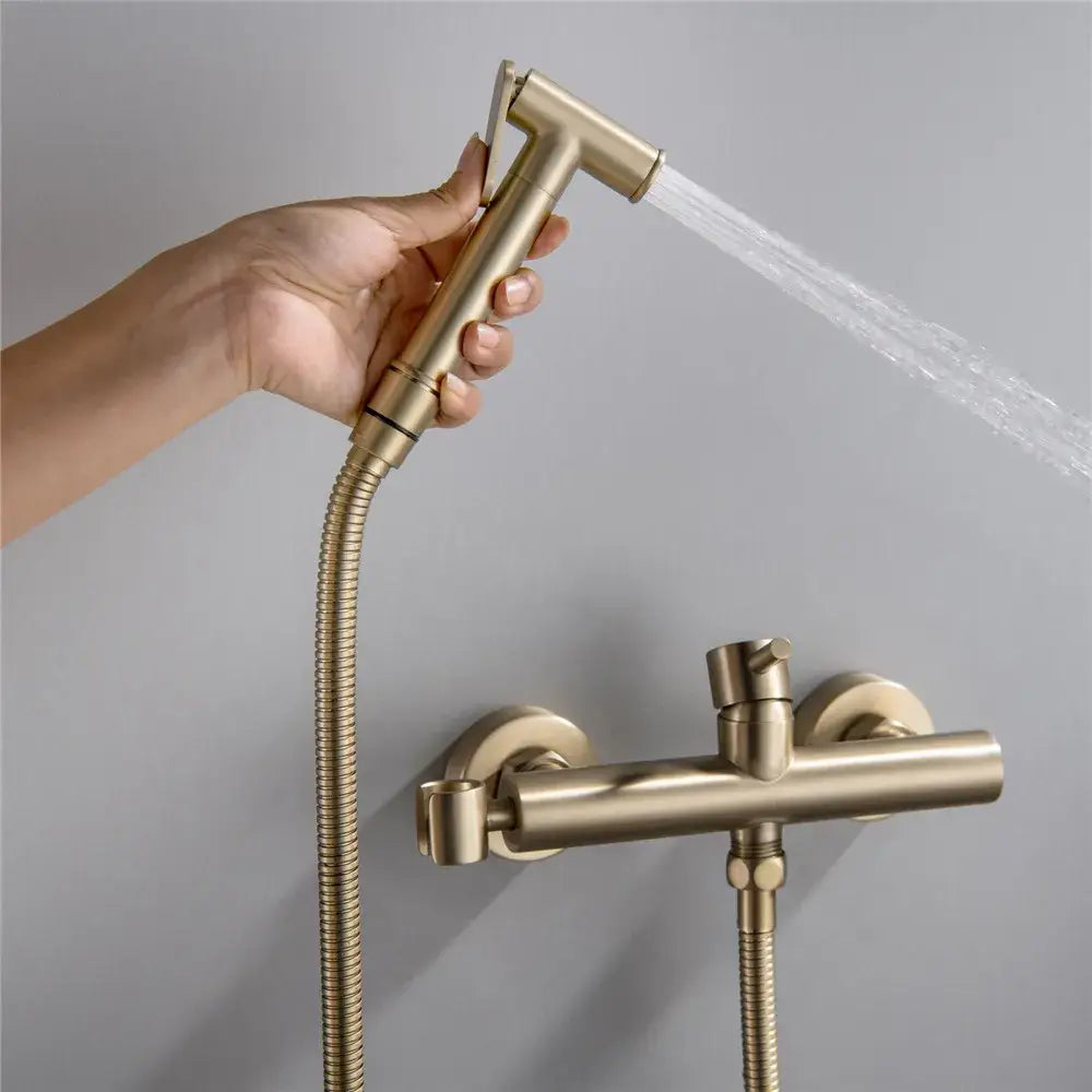 Gold-toned brass modern brushed hand held bidet sprayer kit with flexible hose and wall-mounted faucet assembly