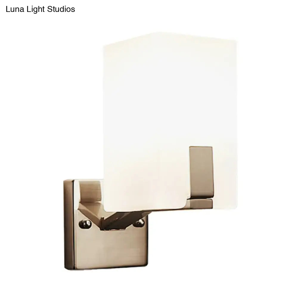 Modern brushed nickel wall sconce with rectangular frosted glass shade showcasing light type for bedroom use