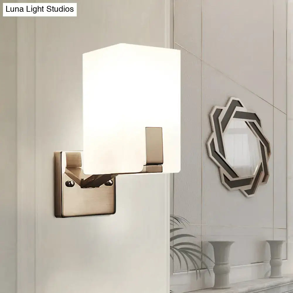 Modern brushed brass wall sconce with frosted white rectangular glass shade for bedroom light type