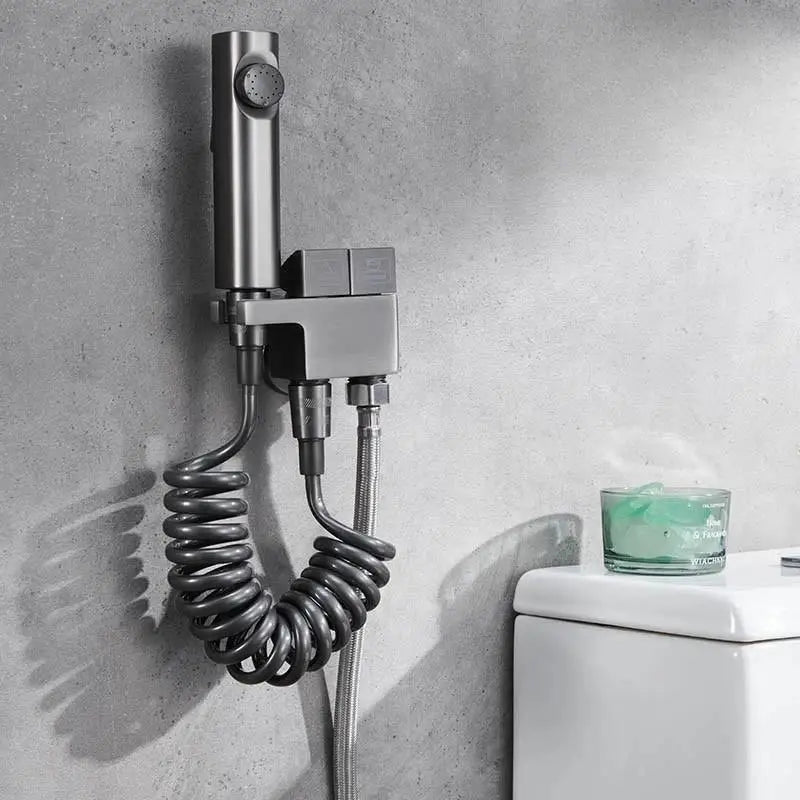 Modern brushed copper bidet spray gun set with stainless steel wall-mounted sprayer and coiled hose for bathroom use