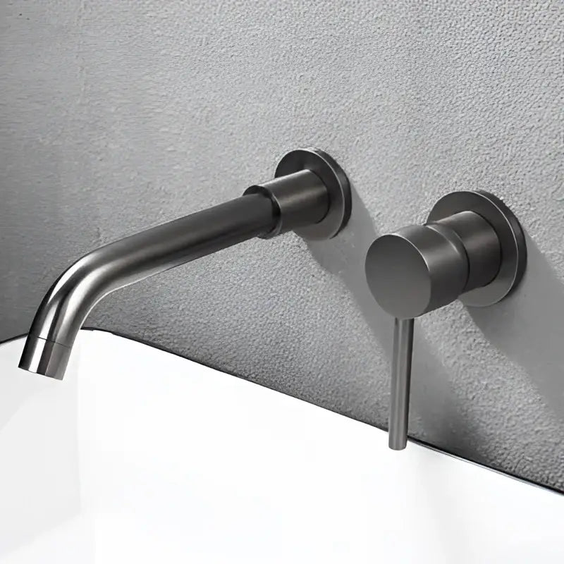 Modern brushed gold and black basin faucet set with matte black wall-mounted faucet and minimalist cylindrical handle