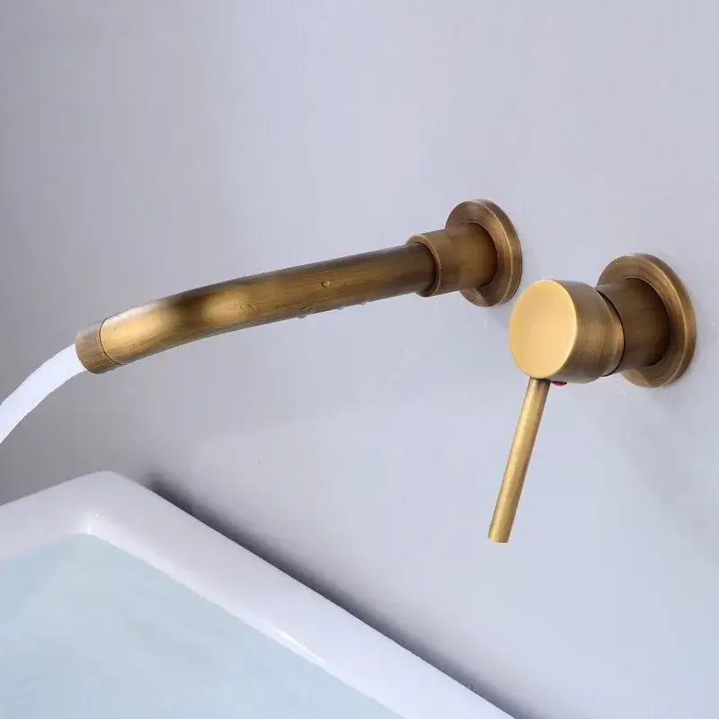 Modern brushed gold and black basin faucet set with brass-finished wall-mounted faucet and curved spout for bathroom sink