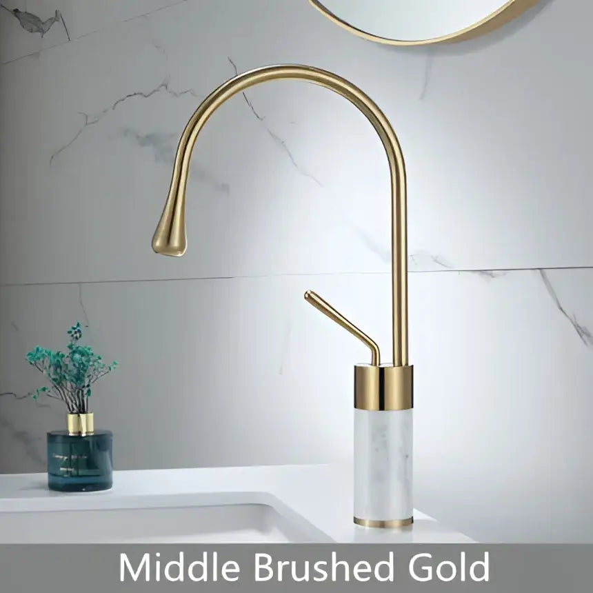 Modern brushed gold bathroom sink faucet with curved spout featuring brushed gold brass finish and marble base