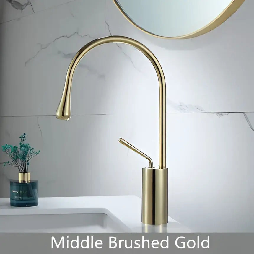 Modern brushed gold brass kitchen faucet with a sleek curved spout and cylindrical base in gold brass finish