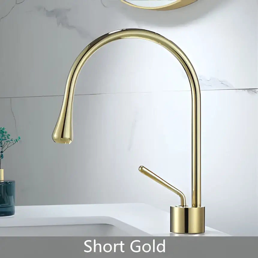 Short brushed gold brass bathroom sink faucet with sleek curved spout and minimalist modern design