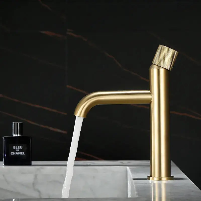 Modern brushed gold basin faucet with textured knurled handle and sleek cylindrical spout decorbites brushed gold