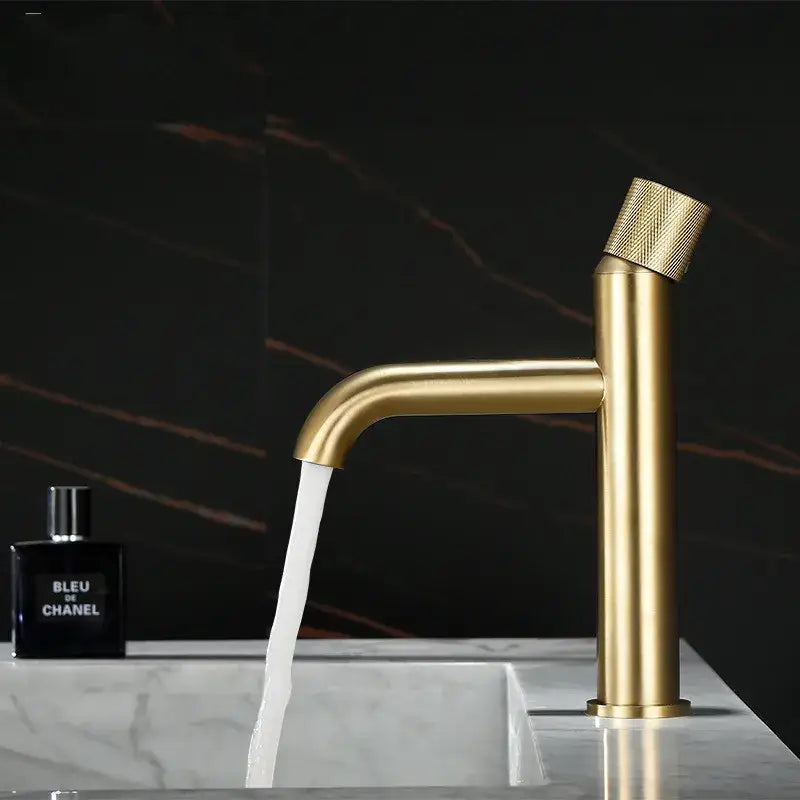 Modern brushed gold basin faucet with textured knurled handle and sleek cylindrical spout decorbites brushed gold