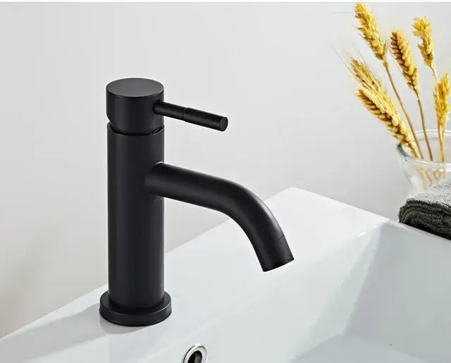 Modern brushed gold basin faucet with black matte finish and sleek cylindrical curved spout by decorbites brushed gold