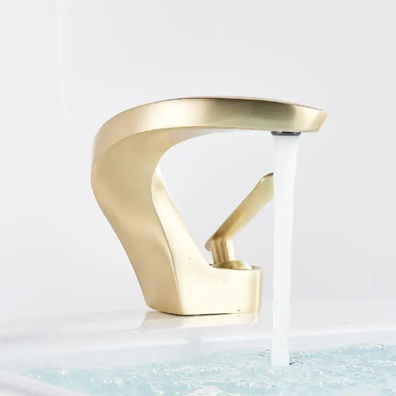Modern brushed gold basin faucet with sleek curved design and single lever mixer tap by decorbites