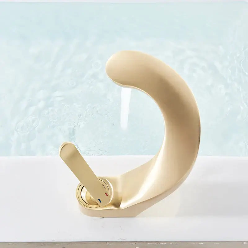 Modern brushed gold basin faucet with sleek curved design and minimalist single lever handle decorbites brushed gold