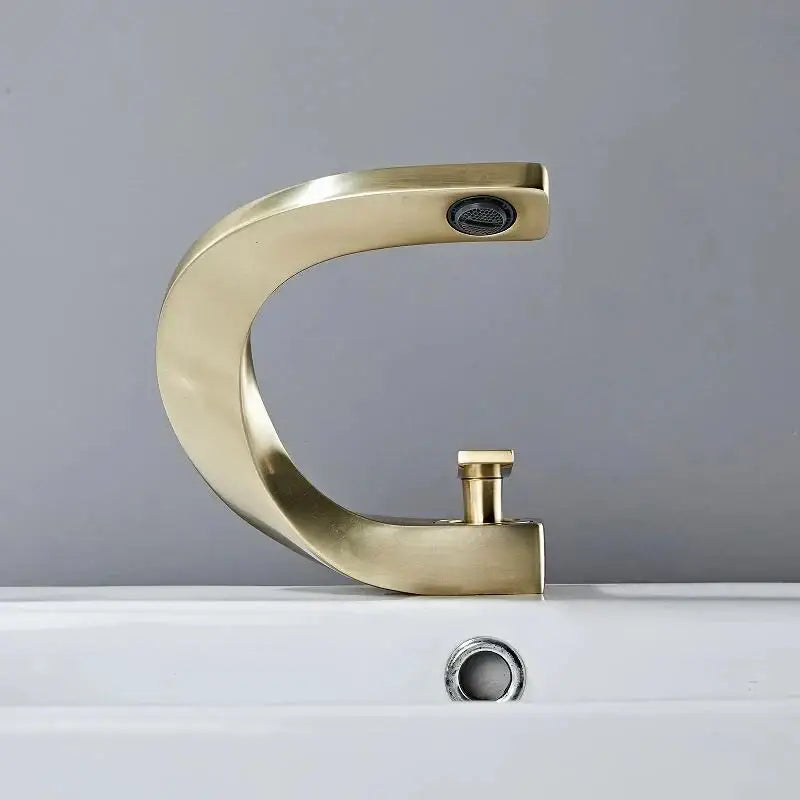 Modern brushed gold basin faucet with brass finish and sleek curved design by decorbites basin faucet
