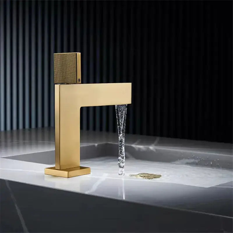 Modern brushed gold basin faucet with textured square handle and sleek rectangular spout by Decorbites brushed gold
