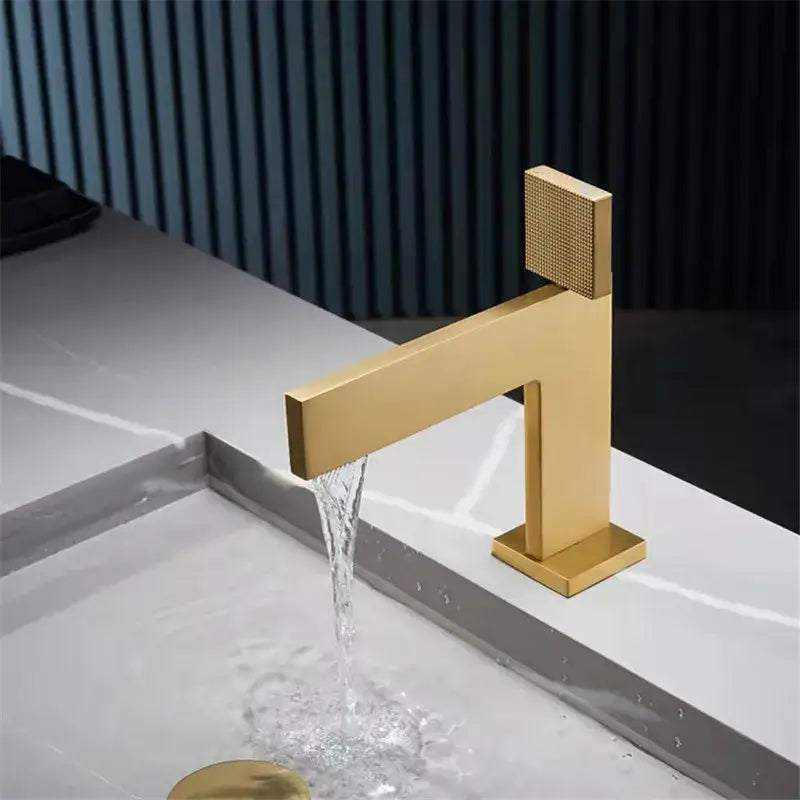 Modern brushed gold basin faucet with a textured square handle and sleek geometric design by decorbites brushed gold