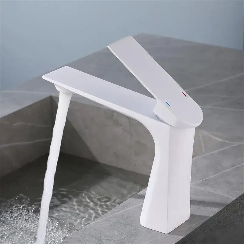 Modern brushed gold basin faucet with a white ceramic waterfall spout featuring sleek minimalist design decorbites brushed gold