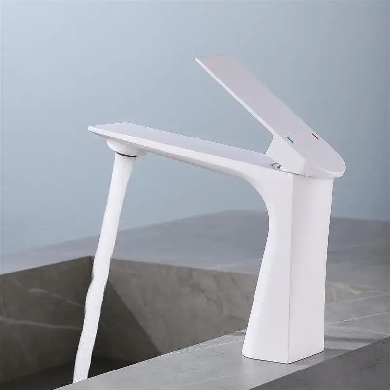Modern white ceramic basin faucet with sleek angular design and waterfall spout in decorbites brushed gold finish