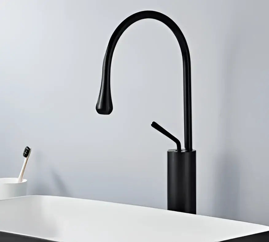 Black matte basin faucet with curved spout and cylindrical base contrasting decorbites brushed gold bathroom faucet