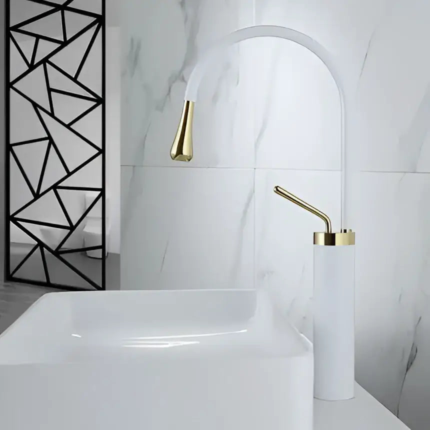 White ceramic sink with a modern brushed gold basin faucet and matching swivel spout by decorbites in bathroom decor