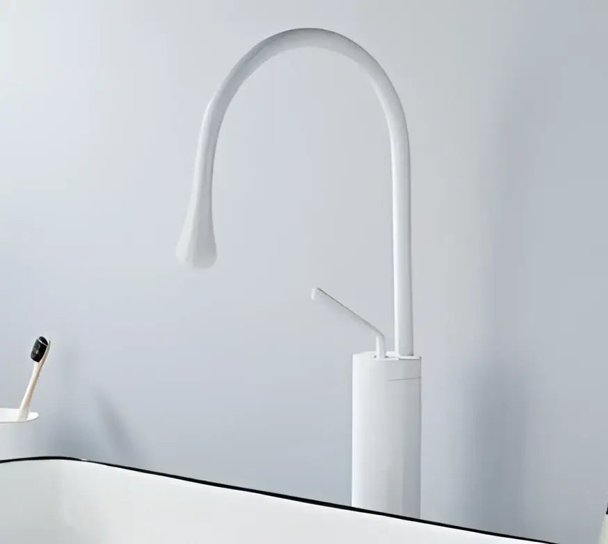 White ceramic basin faucet with sleek curved spout complementing decorbites brushed gold modern design