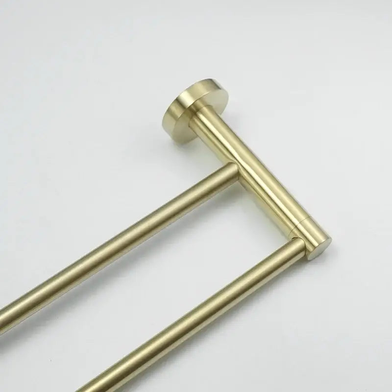 Brass-finished double towel rack with sleek cylindrical bars and polished ends in a modern brushed gold bath hardware set