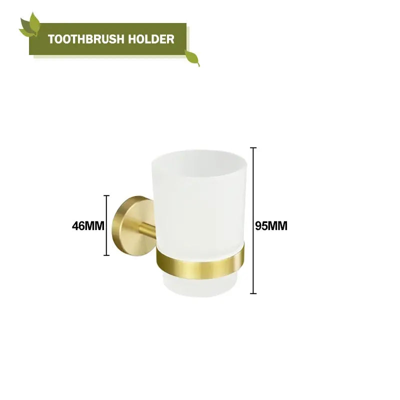 A sleek white frosted glass toothbrush holder with polished gold-tone metal base in modern brushed gold bath hardware set