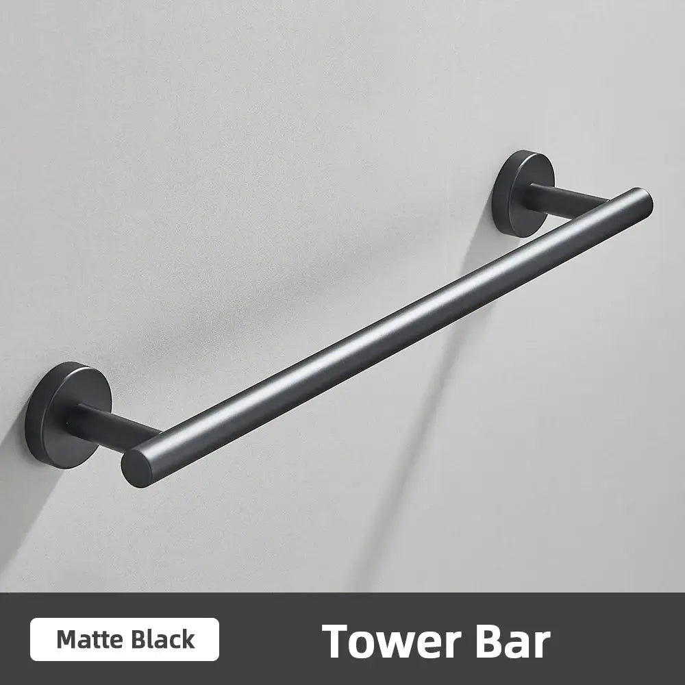 Matte black metal tower bar with sleek cylindrical design in modern brushed gold stainless steel bathroom accessories set