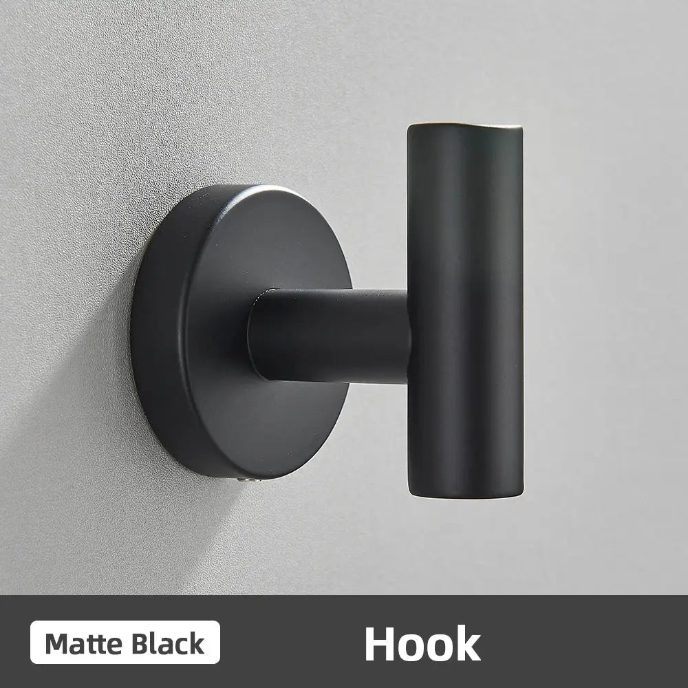 Matte black wall-mounted hook with sleek cylindrical design and circular base in modern brushed gold bathroom accessories set