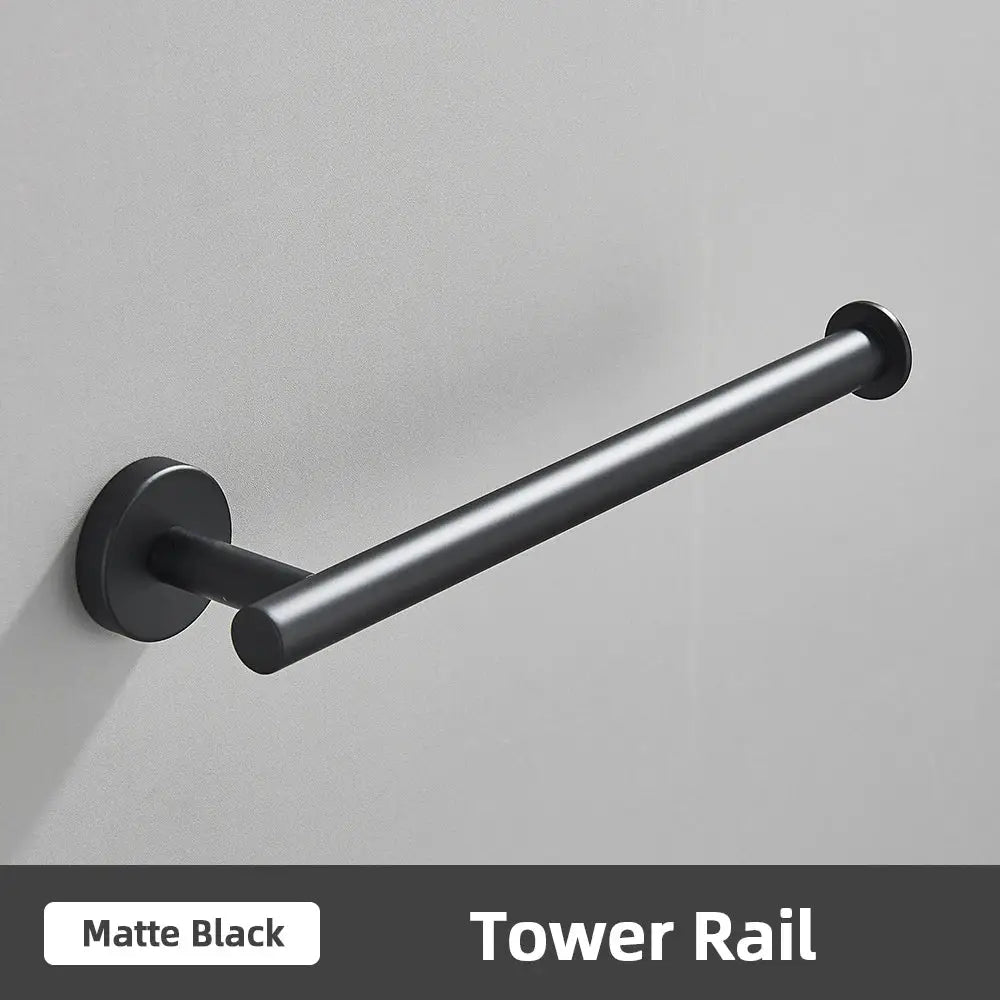 Matte black tower rail with sleek cylindrical design and minimalist mounting hardware for brushed gold bathroom accessories set