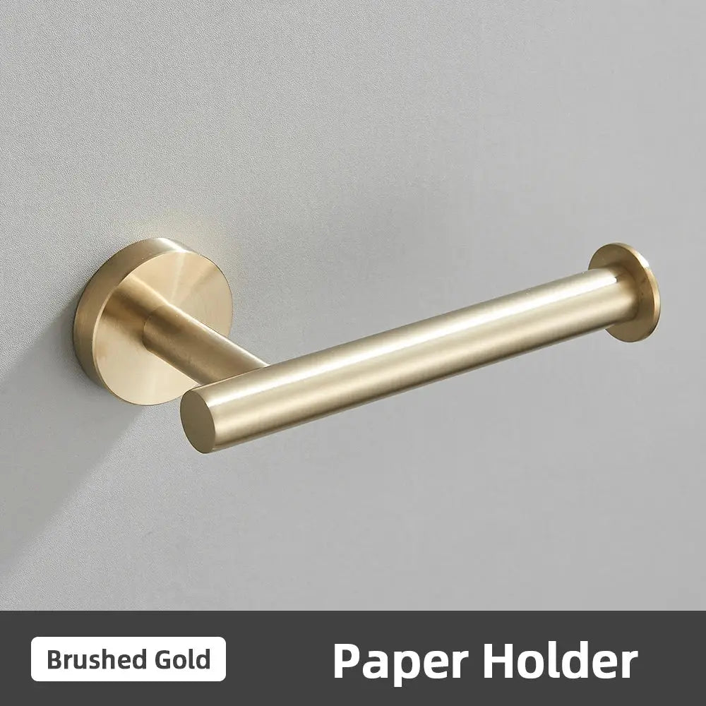 Brushed gold stainless steel toilet paper holder with sleek cylindrical design in modern bathroom accessories set