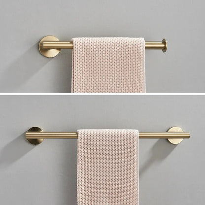 Modern brushed gold wall-mounted towel rack holding a pale pink textured towel in stainless steel bathroom accessories set