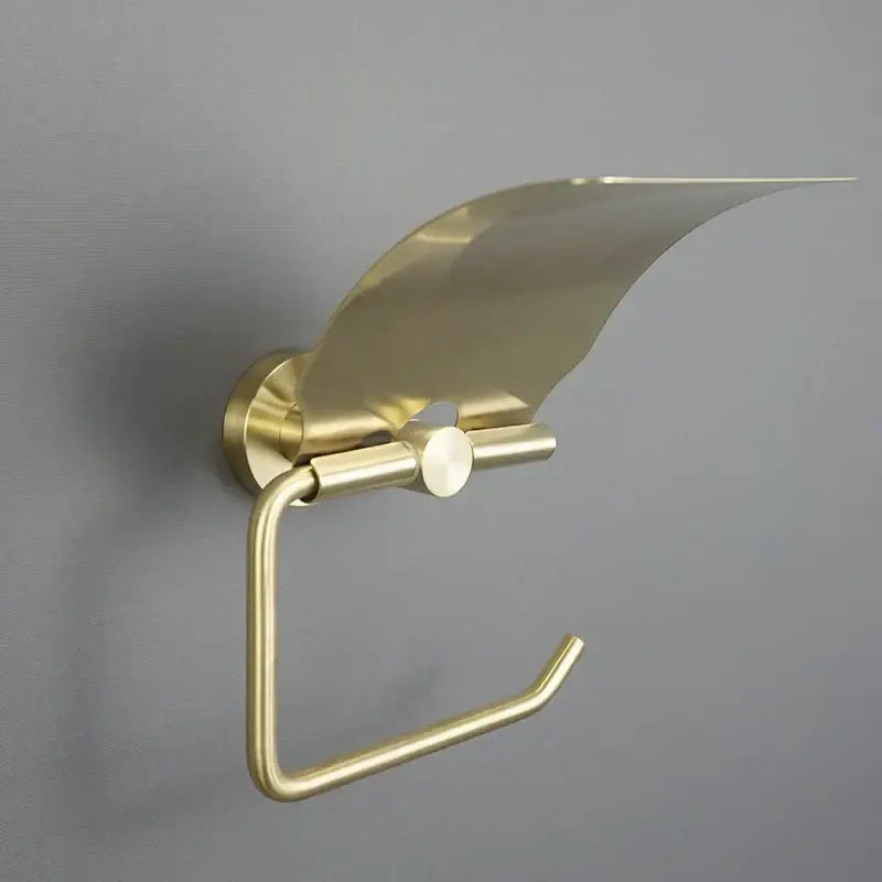 Brass-finished modern toilet paper holder with sleek curved cover in brushed gold bathroom hardware set design