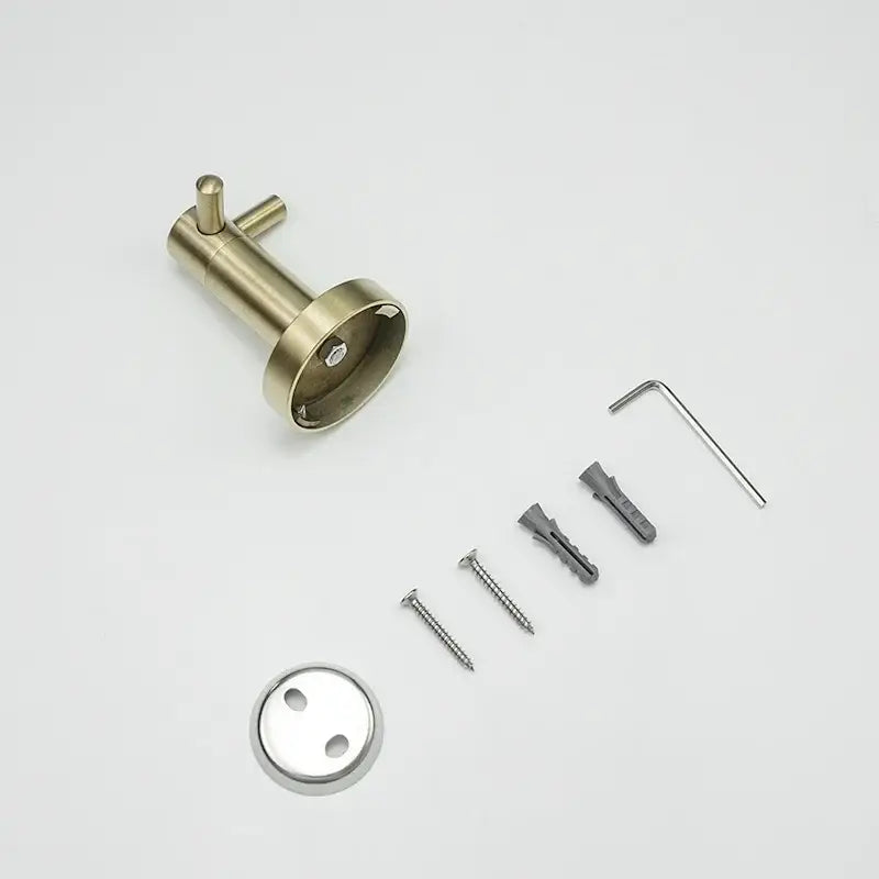 Brass-finished wall-mounted toilet paper holder with circular base and two handles in brushed gold bathroom hardware set